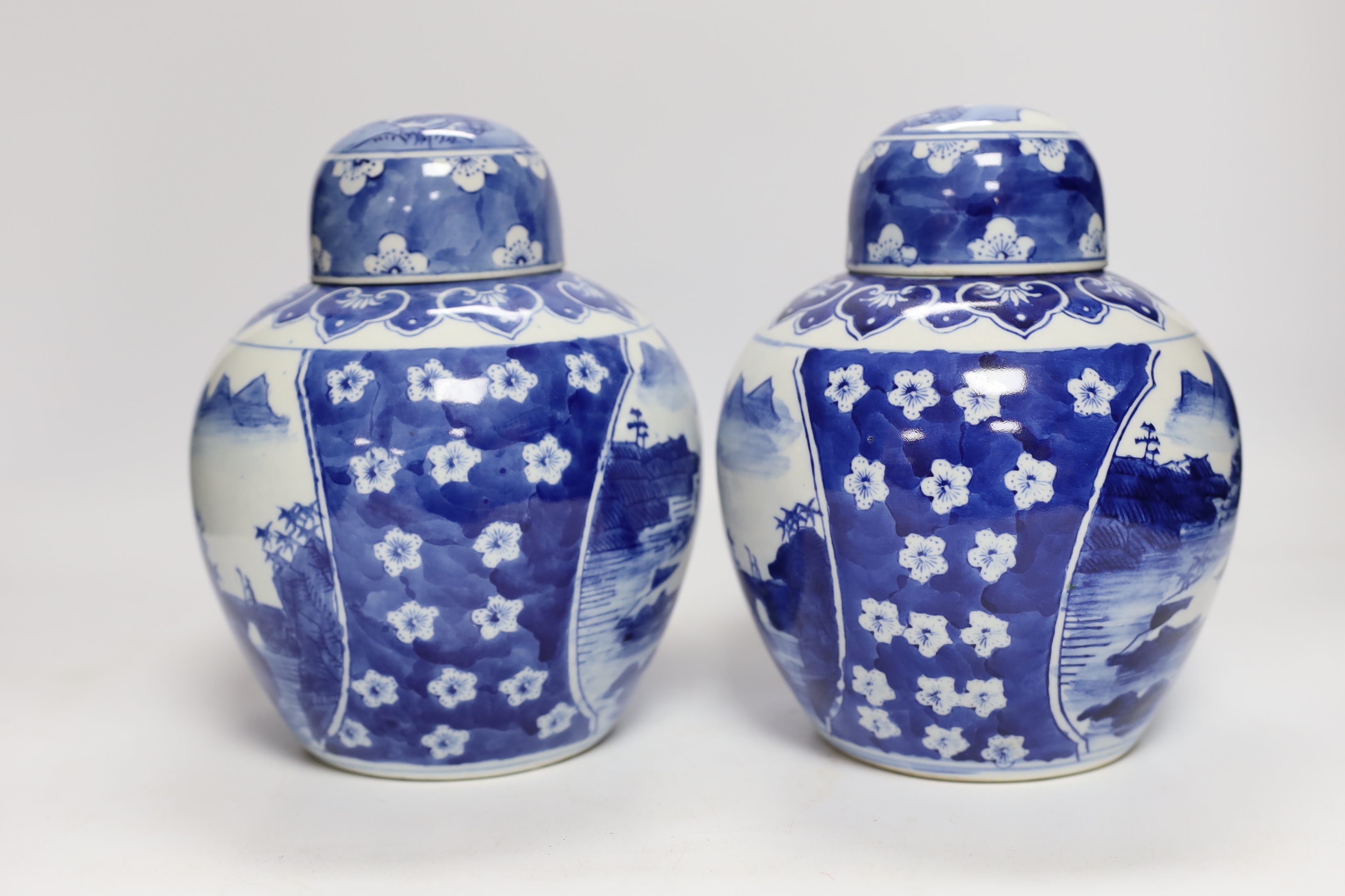 Four Chinese ginger jars, including a blue and white pair with covers and a prunus flower example, largest 21cm high